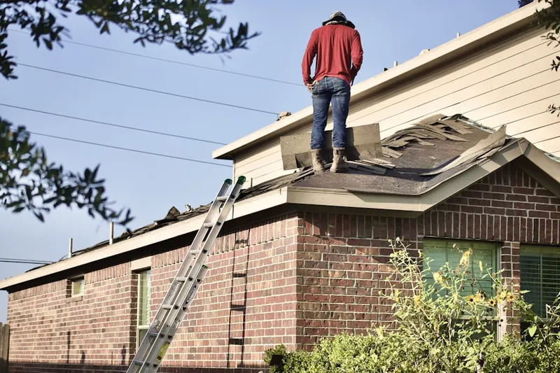 Professional roofer working on a residential roof in Revere